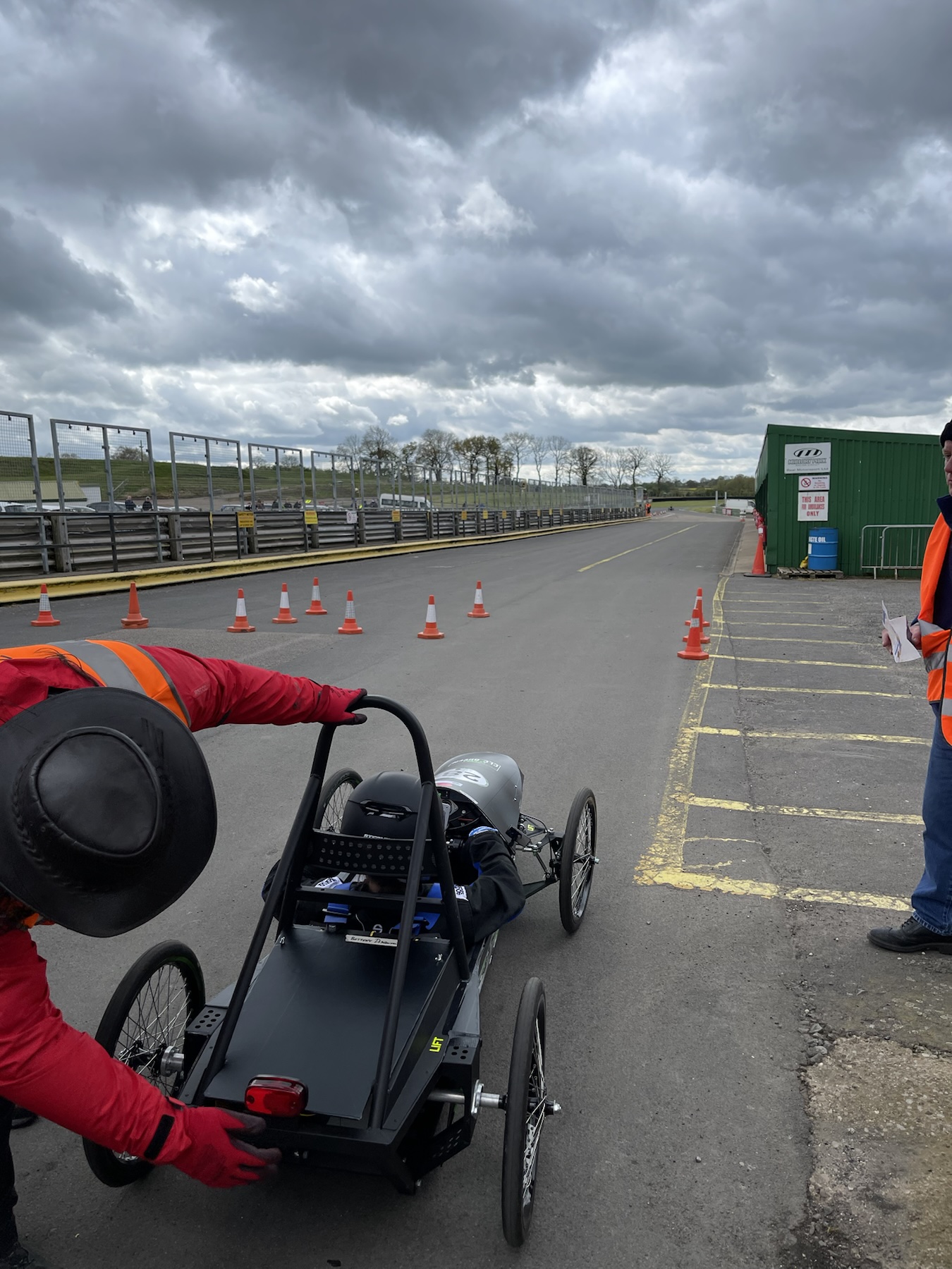 The electric race car and its driver near the Mallory Park pit lane